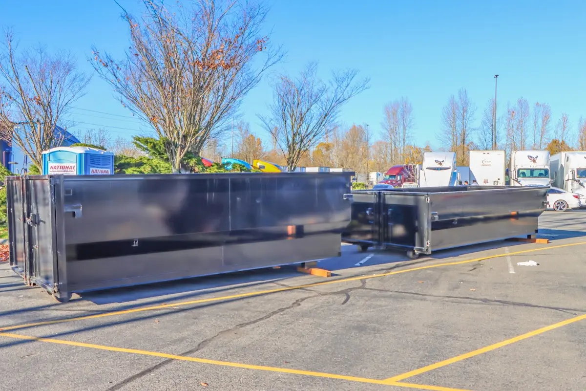 Professional dumpster rental service with roll-off container on residential driveway in Hayden